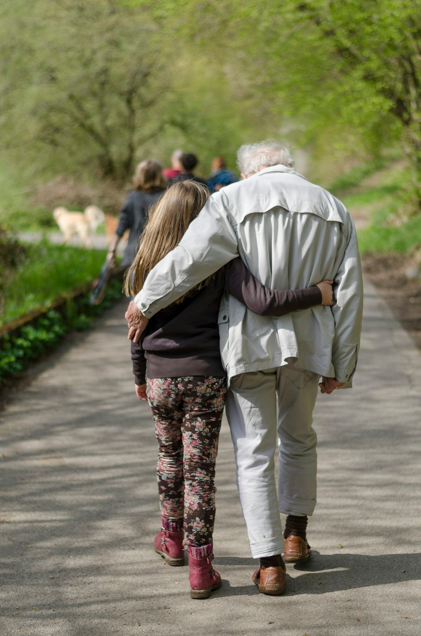 Adult and child walking together on a path