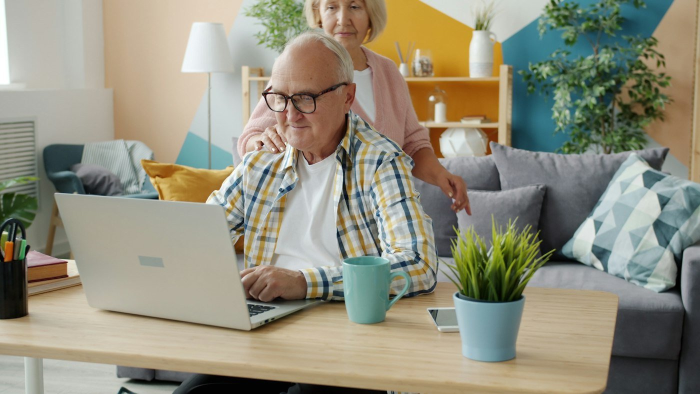 Senior couple using a laptop together at home